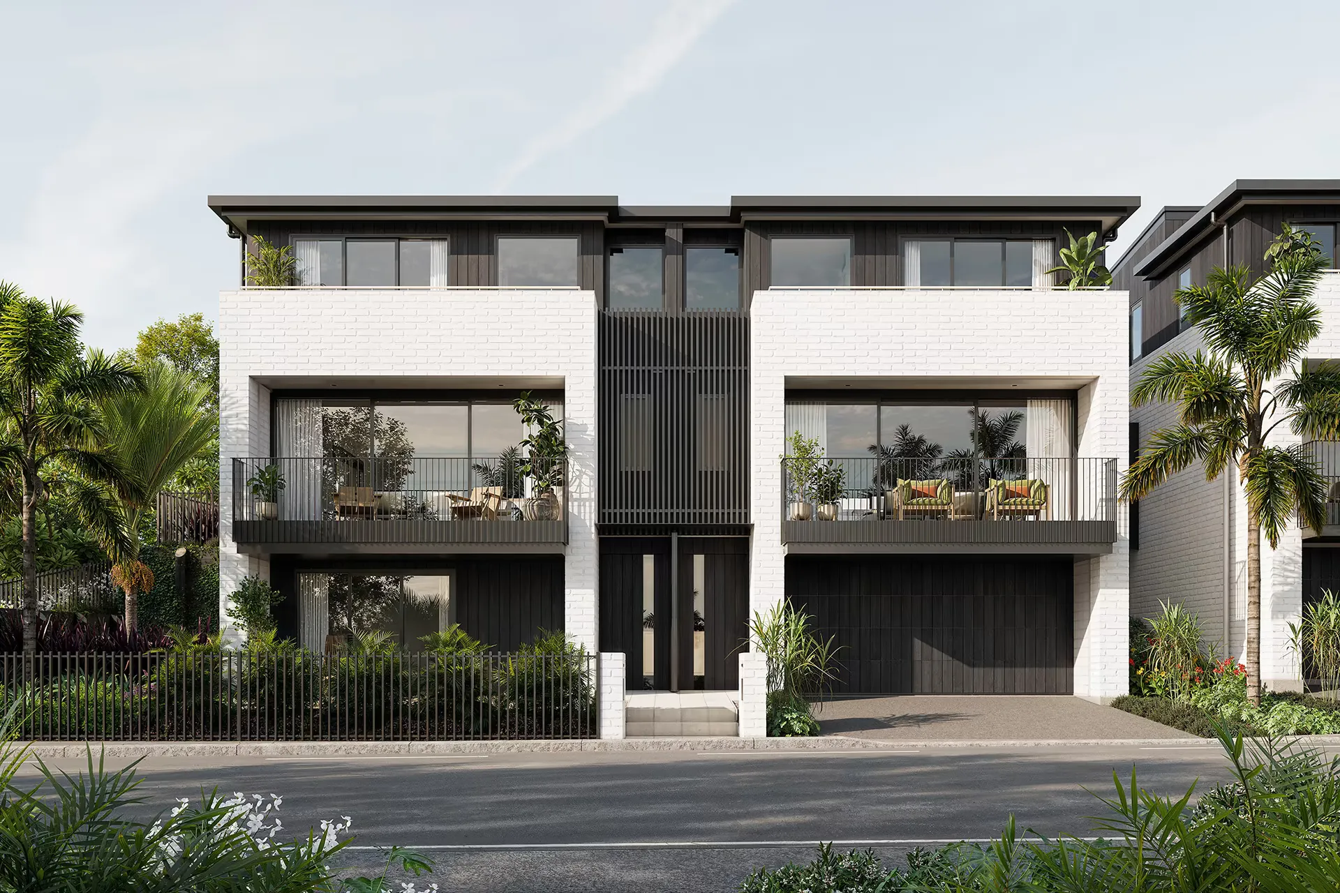 A symmetrical elevation of two units, in white brick with dark cladding between them, balconies above and planting at the boundary.